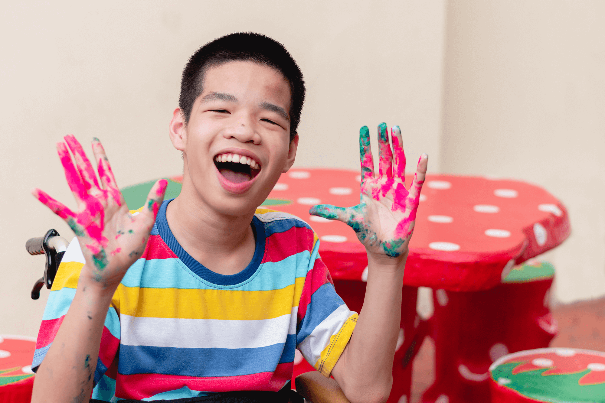 asian-disabled-child-on-wheelchair-smiling-with-hi-2025-01-09-12-47-13-utc 1